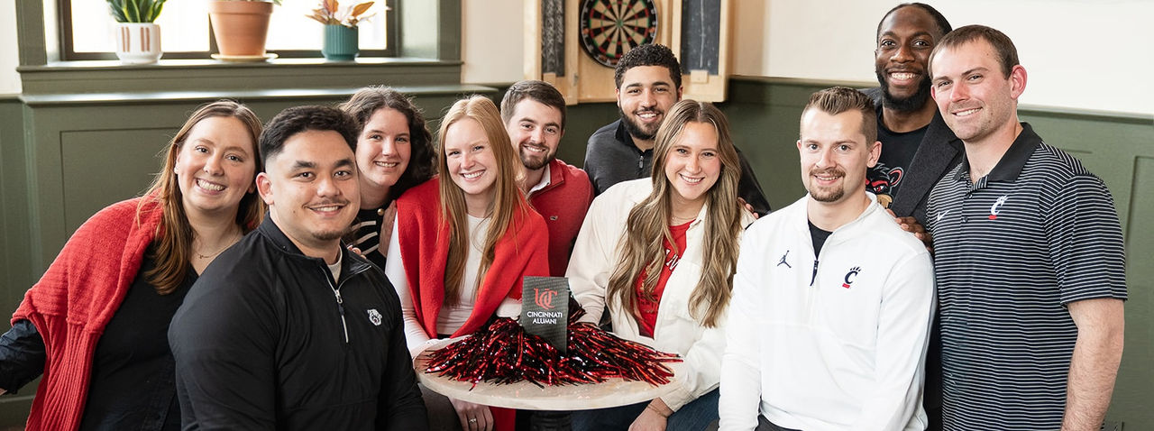 University of Cincinnati Alumni pose for group photo at Mellotone