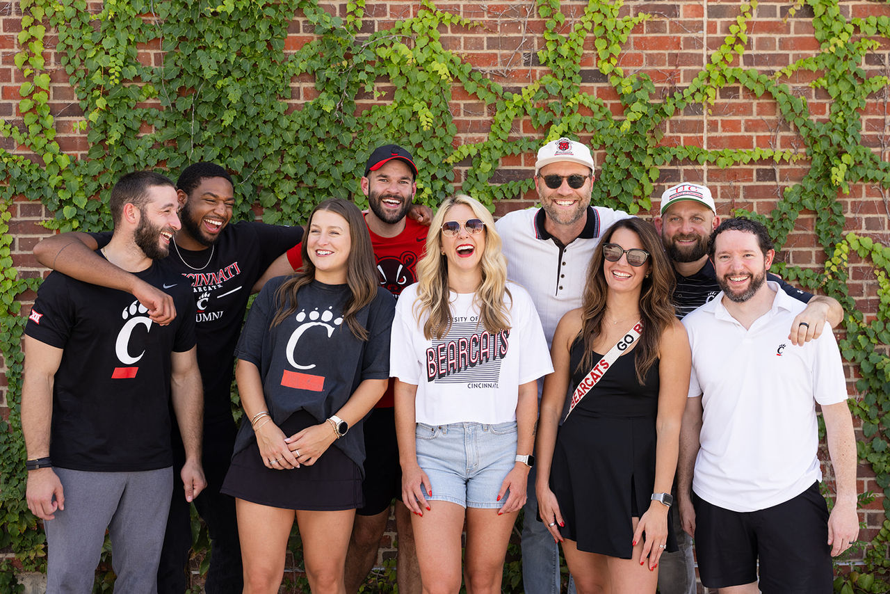 University of Cincinnati Alumni pose for group photo outside of UC Baseball Stadium