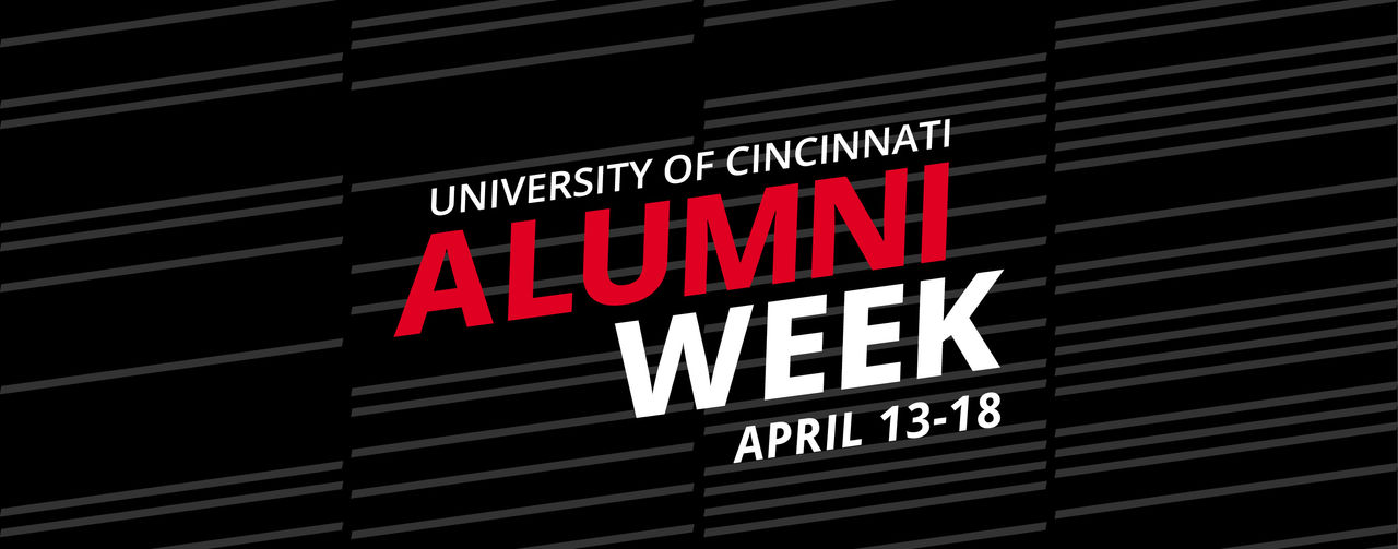 Woman typing on a laptop with a UC Cincinnati Alumni coffee mug next to her