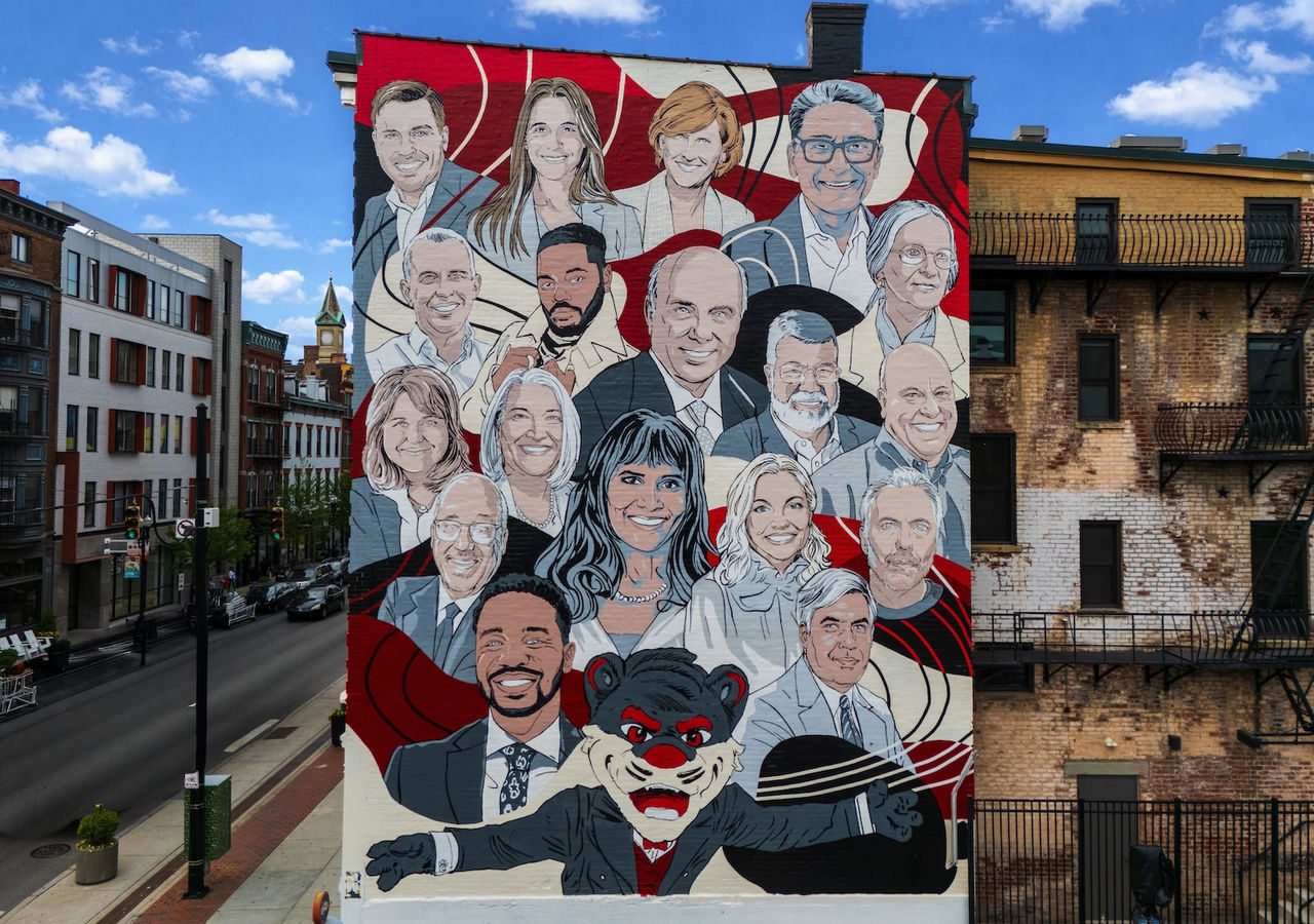 Group of UC students cheering with confetti falling around them