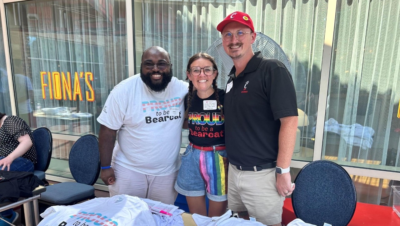 Alumni smiling while at an LGBTQ+ and Friends Alumni Network event